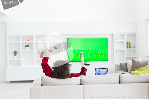 Image of young man in bathrobe enjoying free time