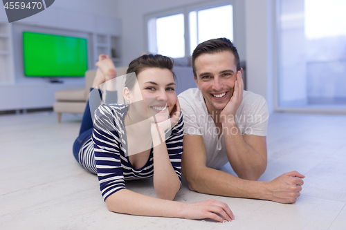 Image of couple lying on the floor at home