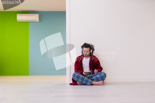 Image of young man enjoying music through headphones