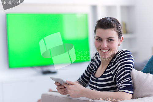 Image of woman on sofa using tablet computer