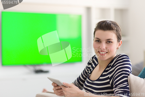 Image of woman on sofa using tablet computer