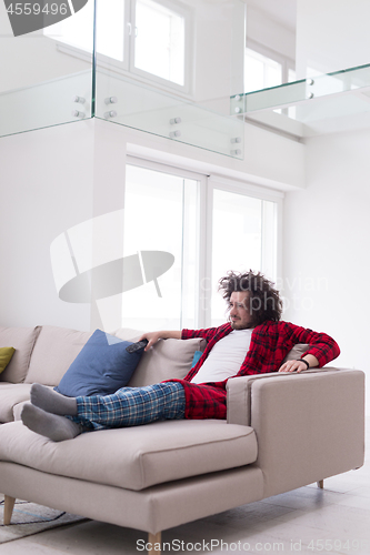 Image of young man in bathrobe enjoying free time