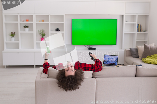 Image of young man in bathrobe enjoying free time