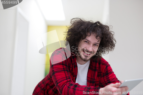 Image of young freelancer using tablet computer