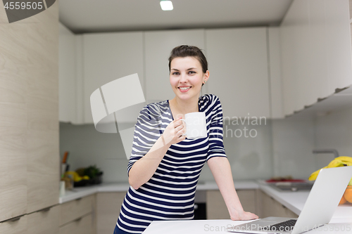 Image of woman drinking coffee enjoying relaxing lifestyle