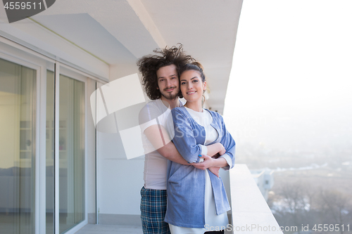 Image of Couple hugging on the balcony