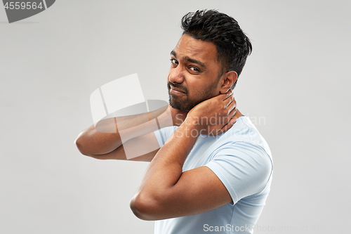 Image of unhealthy indian man suffering from neck pain