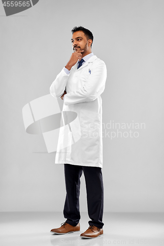 Image of smiling male doctor or scientist in white coat