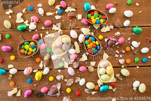 Image of chocolate eggs and candy drops on wooden table