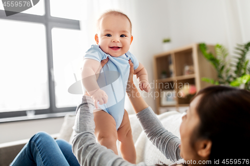 Image of happy mother with little baby son at home