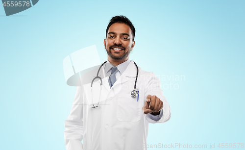 Image of smiling indian male doctor pointing finger to you