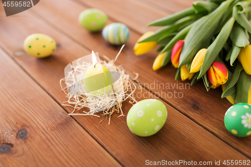 Image of candle in shape of easter eggs and tulip flowers