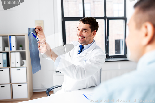 Image of doctor showing x-ray to patient at hospital