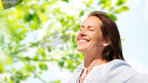 Image of happy woman over green natural background