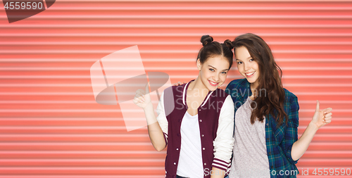 Image of happy teenage girls or friends showing thumbs up