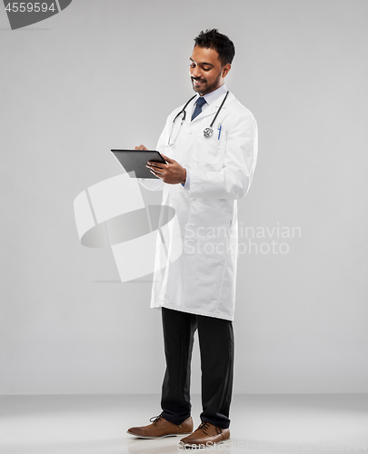 Image of smiling indian male doctor with tablet computer