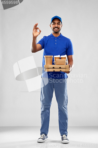 Image of delivery man with food and drinks showing ok