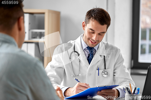 Image of doctor with clipboard and male patient at hospital