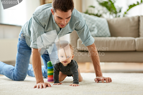 Image of happy little baby girl with father at home