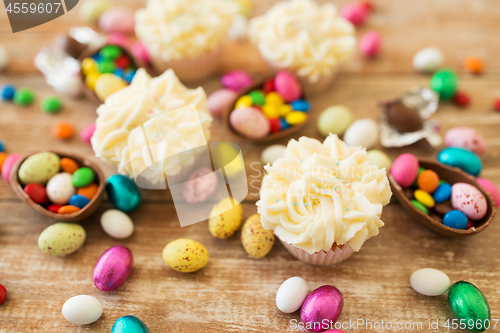 Image of cupcakes with chocolate eggs and candies on table