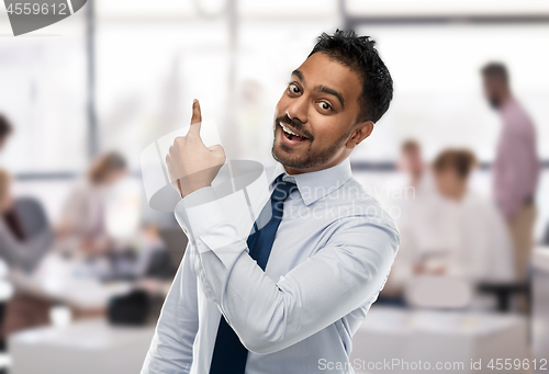 Image of indian businessman pointing finger at something