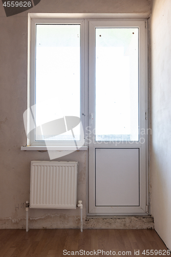 Image of Exit to the balcony in the interior of an unrepaired room