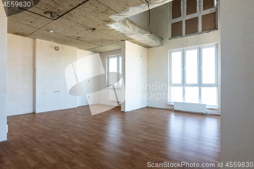 Image of The interior of the spacious apartment without repair, with laminate flooring