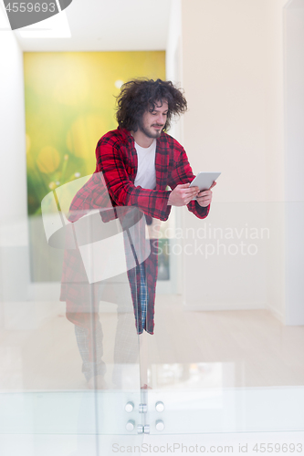 Image of young freelancer using tablet computer