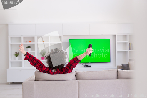 Image of young man in bathrobe enjoying free time