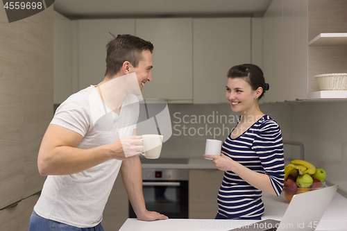 Image of couple with laptop computer enjoying morning