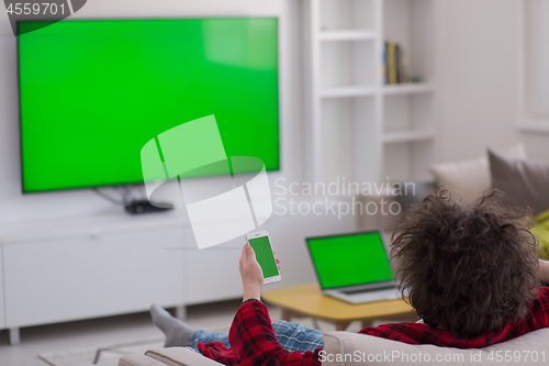 Image of young man in bathrobe enjoying free time