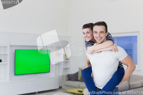 Image of handsome man piggybacking his girlfriend
