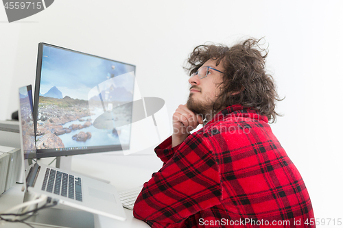 Image of graphic designer in bathrobe working at home