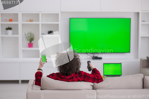 Image of young man in bathrobe enjoying free time