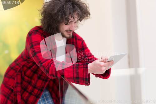 Image of young freelancer using tablet computer