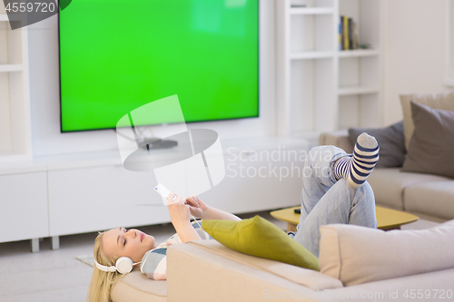 Image of girl enjoying music through headphones