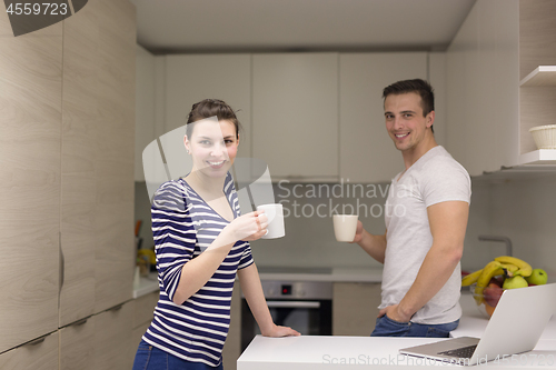 Image of couple with laptop computer enjoying morning