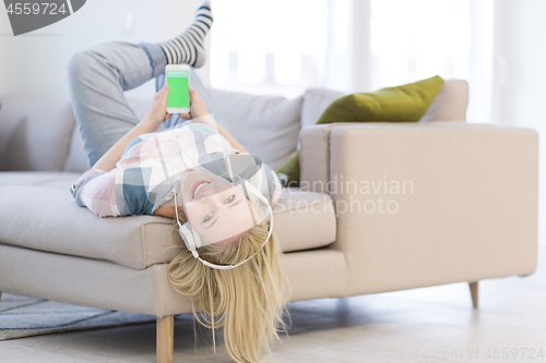 Image of girl enjoying music through headphones