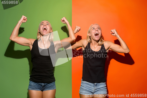 Image of Winning success women happy ecstatic celebrating being a winner. Dynamic energetic image of female models