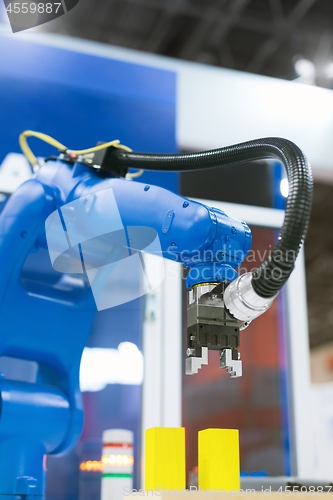 Image of Automatic robot arm working in industrial environment