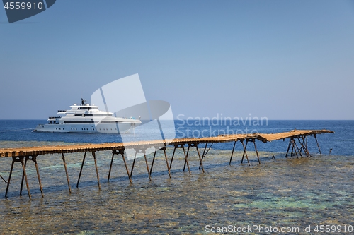 Image of Long wooden piel leading into the sea