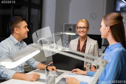 Image of business team working at night office