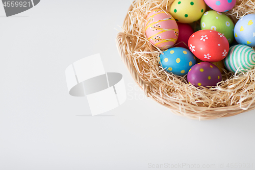 Image of close up of colored easter eggs in basket