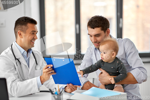 Image of father with baby and doctor at clinic