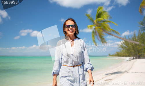 Image of happy woman over tropical beach background