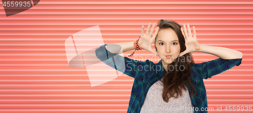 Image of happy teenage girl making face and having fun