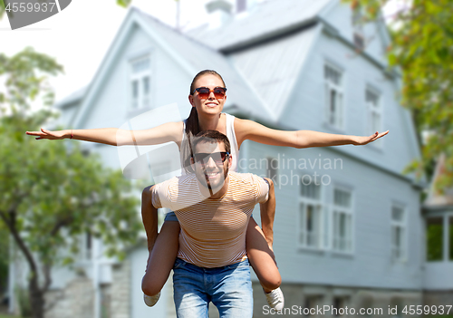 Image of happy couple having fun in summer over house