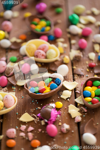 Image of chocolate eggs and candy drops on wooden table