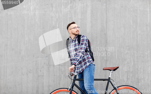 Image of hipster man with fixed gear bike and backpack