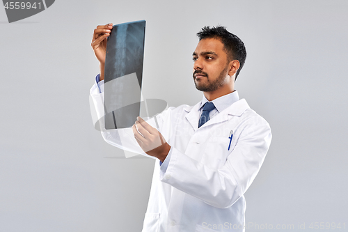 Image of indian doctor looking at spine x-ray